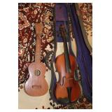 Old violin in case and a ukulele