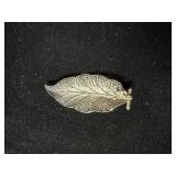 Filigree leaf brooch marked with an A and