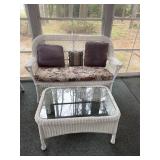 Wicker style loveseat and coffee table with glass