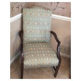 High-back armchair with green fabric decorated