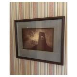Framed photo of the sun shining through a church