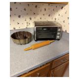 Toaster oven, wooden rolling pin, a