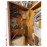 Wood shaper cutters and more in gray cabinet