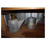 2 metal watering cans