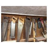 Lot of hand saws hanging on wall