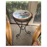 Wrought iron patio table with a cement mallard top