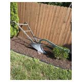 Antique walk behind plow and wooden and metal