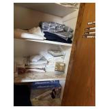 Linens in bathroom closet - pillow cases, sheets,