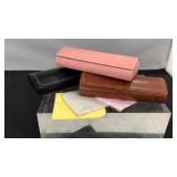 Three eyeglass cases with towels