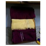 Group of maroon and yellow bath towels all look Group of maroon and yellow bath towels all look