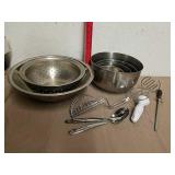 Metal mixing bowls with kitchen utensils