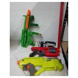 Two Nerf guns with two other Nerf type guns