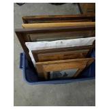 Tote full of various framed artwork
