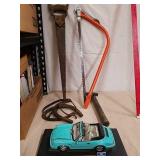 Tools with Porsche model car on stand