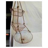 Three tiered copper colored wire hanging basket Three tiered copper colored wire hanging basket
