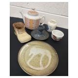 Group of teapot, clay plate, candle holder and