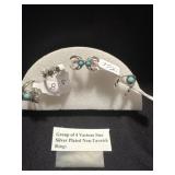 Group of 4 various size rings silver plated non