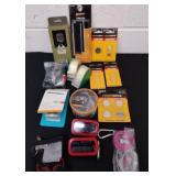Earbuds, batteries, paper and quick strip tape