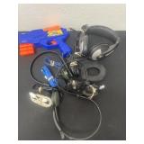 Group of headsets and cords and gun