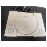 PlayStation with cords.