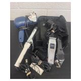 Group of hair clippers and curling iron and blow