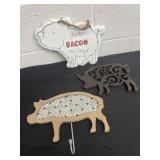 Enamel pig sign. And cast trivet and pig hook