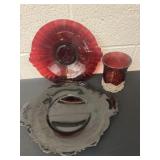 2 red glass plates and candle holder