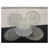 4 glass plates and glass cake plate with cover