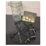 Group of cookie cutters and glass canister