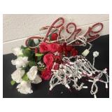 Light up love sign with floral and pink lights