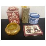 Candle with tins and round glass vase