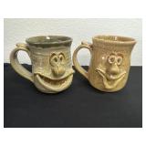 2 pottery face cups