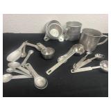 Group of aluminum measuring cups and spoons