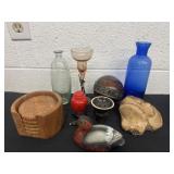 Group of glass bottles and figurines and coasters