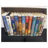 Group of vhs with case of dvds