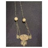 vintage yellow gold necklace featuring carved