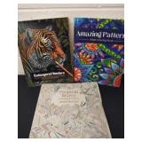 Three adult coloring books two have been used