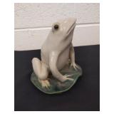 Vintage ceramic frog figurine on a lily pad with