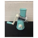 rotary cheese and vegetable grater in a teal