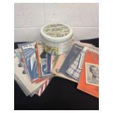Group of vintage sheet music with tin