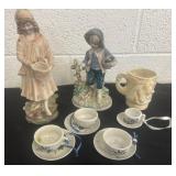 Mini teacups and saucers with figurines and