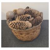 Basket with pine cones , coconut and other decor