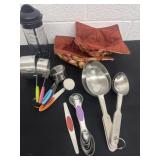 Group of measuring cup and spoons and hot pads