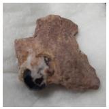 Unique rock with an embedded glass gemstone