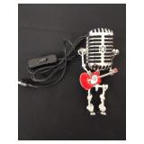 Retro microphone robot holding guitar