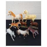 Group of plastic toy horses in various heights