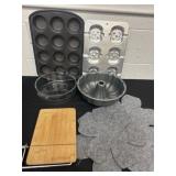 Group of being pans, cutter board, bundt pan and