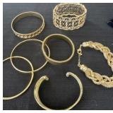 7 gold colored bracelets