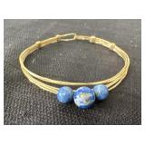 handmade wire-wrapped bangle bracelet featuring