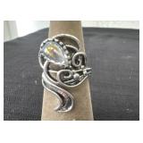 silver-toned ring features an iridescent